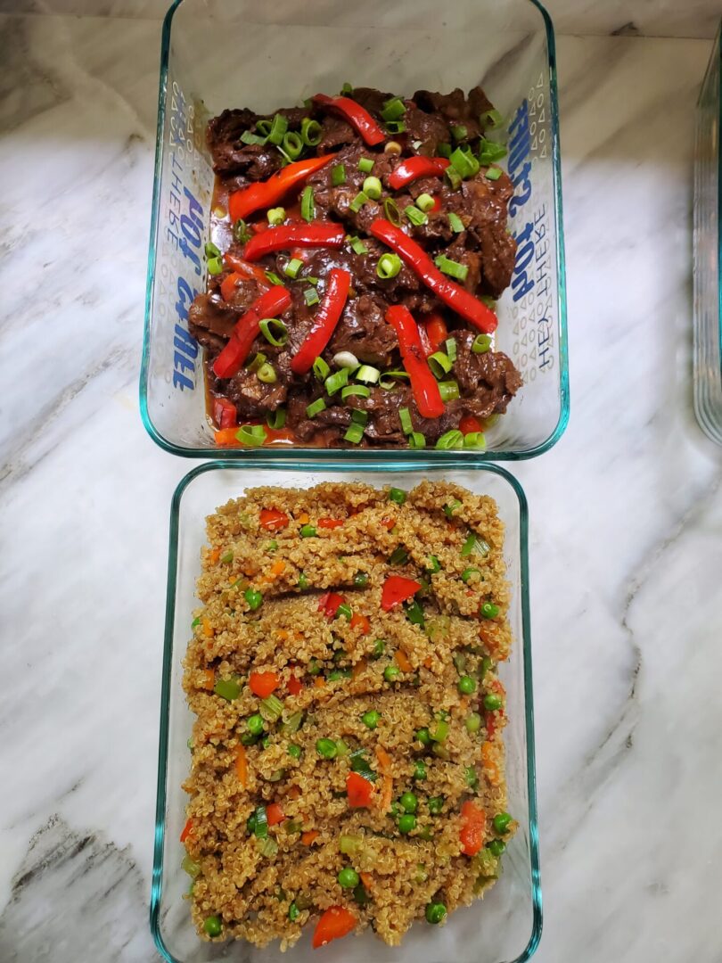 A plate of Quinoa and Vegetable Fried Rice, featuring a colorful mix of cooked quinoa, chopped celery, red bell pepper, green onions, peas, and carrots. The dish is seasoned with soy sauce, ginger, garlic, rice wine vinegar, and sesame oil, creating a mouthwatering and nutritious meal.